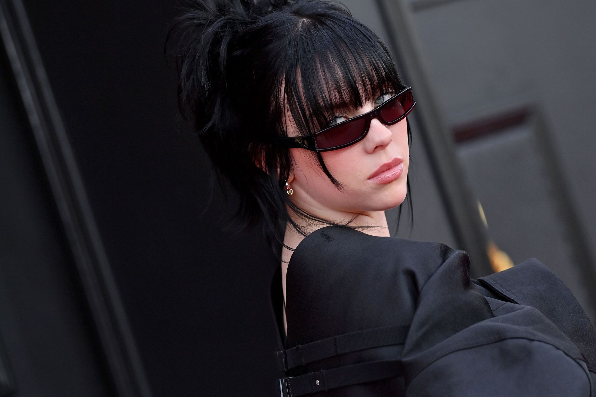 Billie Eilish attends the GRAMMY Awards, 2022 in Las Vegas wearing rose tinted glasses
